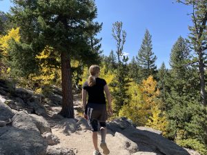 girl looking at fall leaves in Colorado