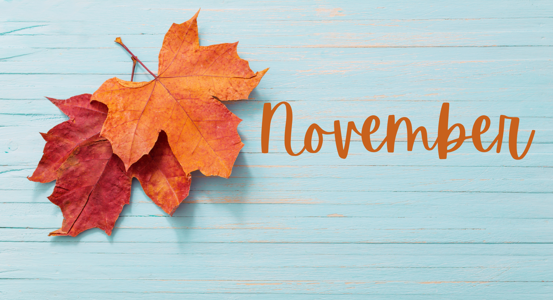 fall leaves against blue wood background and November test