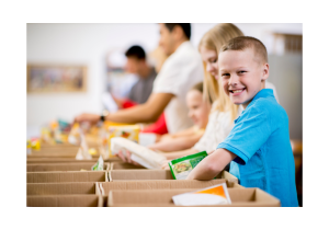 Kids sorting and packing food at a food shelter. 