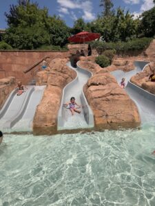 Children slide into the shallow pool at the Sopris Splash Zone at Glenwood Hot Springs Resort in Glenwood Springs, Colorado.