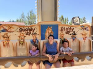 A mother and two young children ride the Giddy Up attraction at Glenwood Caverns Adventure Park in Glenwood Springs, Colorado.